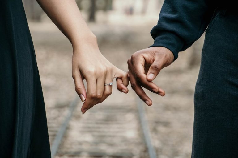 young married couple holding hands